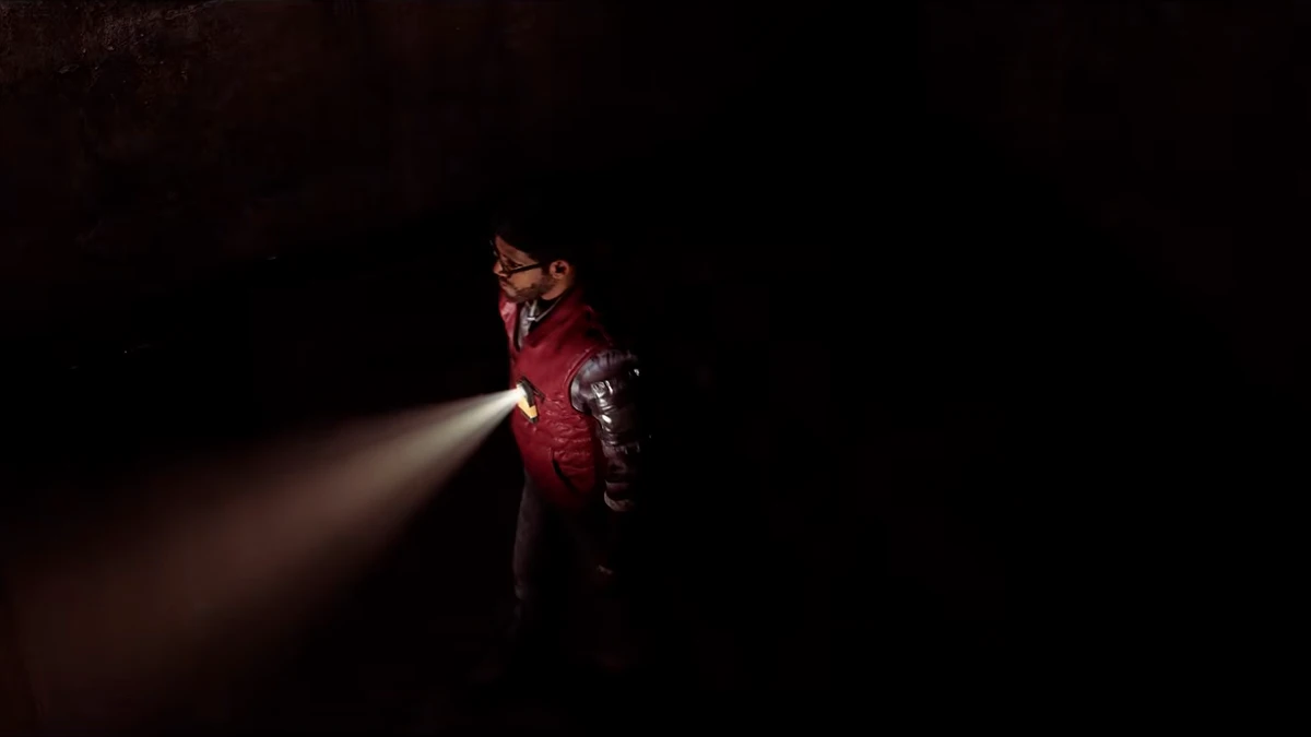 A dark interior lit only by flashlight