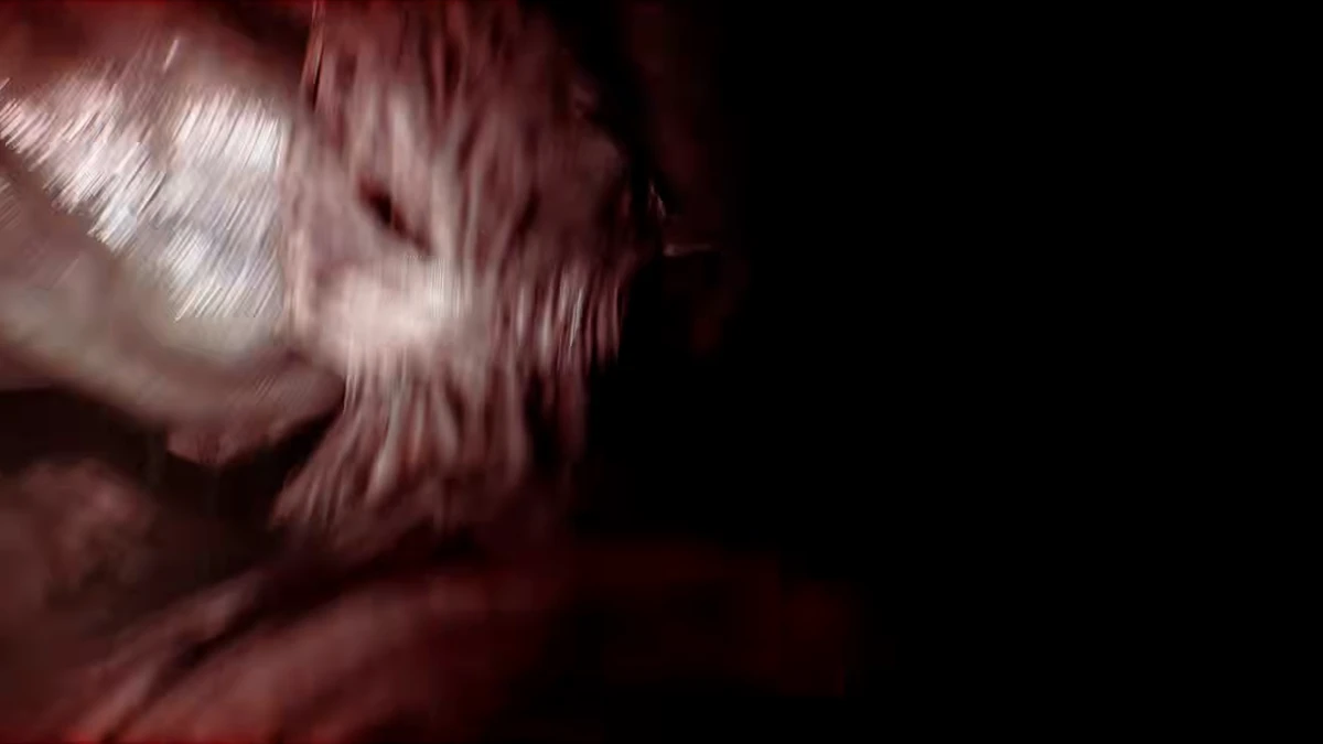 A creature’s face emerging from darkness