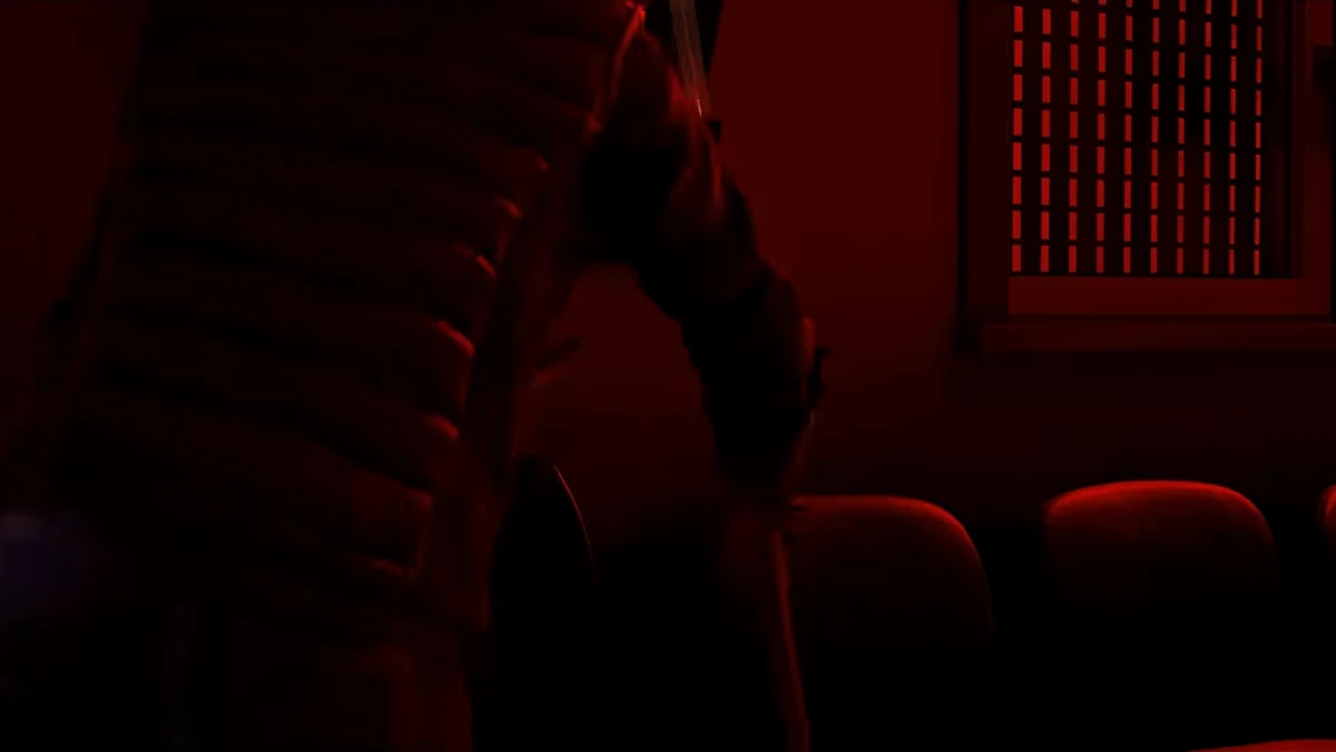 A dark interior room washed in red light